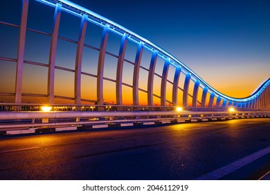 Beautiful view of Meydan Bridge in Dubai. Modern artistic bridge in Dubai. Night architectural shot of a bridge with curvy blue lights. - Powered by Shutterstock