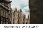 A beautiful view of the Milan Cathedral (Duomo) from behind a column