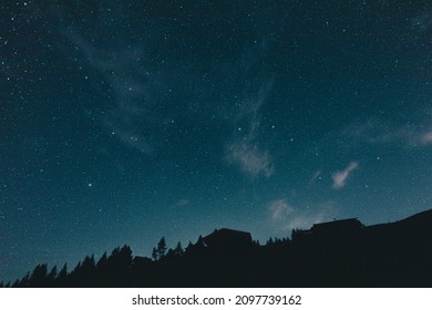 A beautiful view of the Milky way and stars in the evening sky over a landscape in Austria