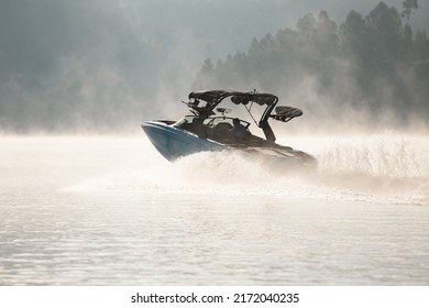 beautiful view of modern bright blue motorboat quickly floating on the water. Shore with houses in the background - Powered by Shutterstock