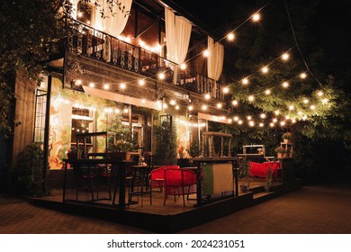 Beautiful View Of Modern Cafe With Outdoor Terrace At Night