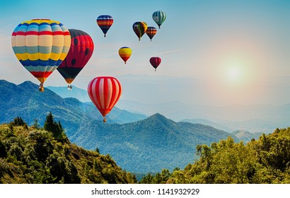 Beautiful view of mountain with hot air balloons on morning at Thailand.