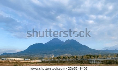 A beautiful view of the mountains in the distance and clear sky. Called mountain Penanggungan in indonesia. East Java, surabaya
