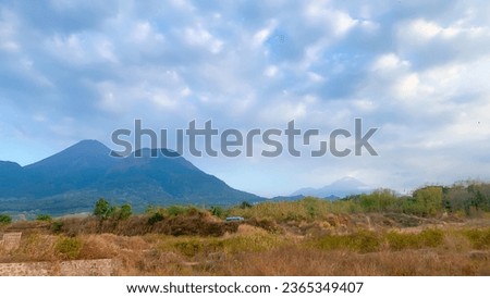 A beautiful view of the mountains in the distance and clear sky. Called mountain Penanggungan in indonesia. East Java, surabaya
