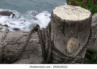Beautiful view of the ocean. Sea coast of Taiwan. Rough sea view from the cliff. Old wooden fence with a rope branch around it. - Shutterstock ID 1904128321