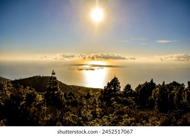 A beautiful view of the ocean with the sun shining on the water. The sky is clear and the sun is setting, creating a warm and peaceful atmosphere - Powered by Shutterstock