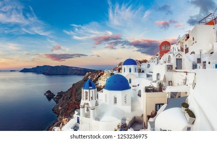 Beautiful view of Oia village on Santorini island in Greece at sunrise with dramatic sky. 