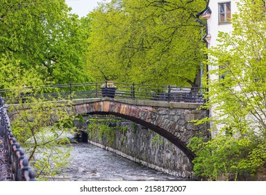 Beautiful view of old bridge across river on spring day. Europe. Sweden. Uppsala.