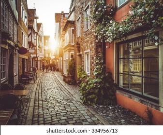 Beautiful view of old town in Europe in beautiful golden evening light at sunset in summer with pastel toned retro vintage Instagram style grunge filter and lens flare sunlight effect - Powered by Shutterstock