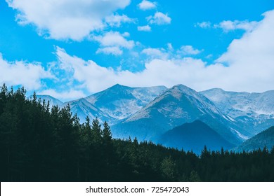 Beautiful View On The High Green Mountains Peaks, On The Blue Sky Background. Mountain Hiking Paradise Landscape, No People.