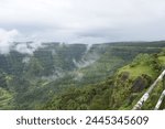 A beautiful view of the Panchgani Hills covered in the misty landscape from Tableland Point in Mahabaleshwar. Tableland is world