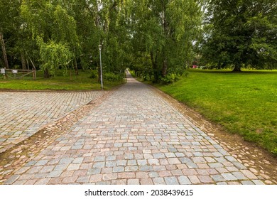 Beautiful view of park with old cobblestone pavement stone walkway background. Cobblestone pavement texture. Sweden.
