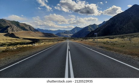 beautiful view of the paved road with road markings running in a mountainous area on a sunny autumn day - Shutterstock ID 2120523935