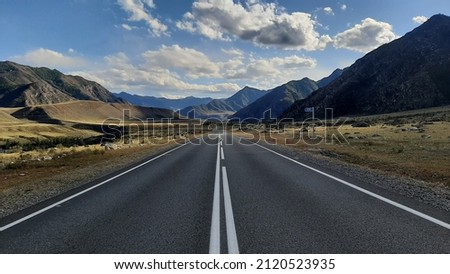 beautiful view of the paved road with road markings running in a mountainous area on a sunny autumn day Stockfoto © 