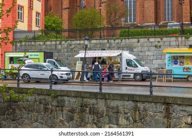 Beautiful view of people outside food truck in downtown. Sweden. Uppsala. 05.14.2022.
