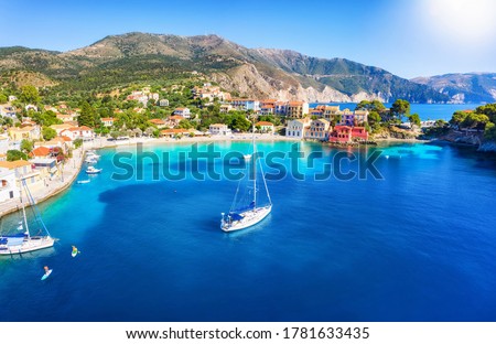 Beautiful view to the picturesque fishing village of Assos, Kefalonia, Greece, with sailing boats moored over the turquoise sea