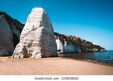 A Beautiful View Of The Pizzomunno, A Large White Rock Monolith In Spiaggia Di Castello Beach In Italy