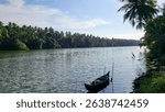 Beautiful view of river in Kerala with small canoe or boat.