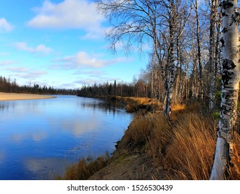 Beautiful view of the river with reflection of clouds and blue sky. Autumn. North.