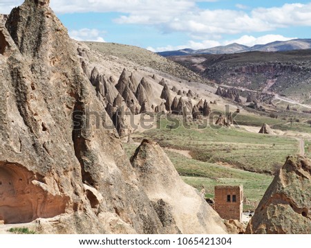 Beautiful view of rock-cut monastery in Selime, Cappadocia, Turkey with mountain and blue sky background.