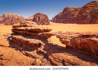 Beautiful view of rocky arch and amazing red rock formations, mountains and sand in famous Wadi Rum desert, Jordan during hot sunny day. - Powered by Shutterstock