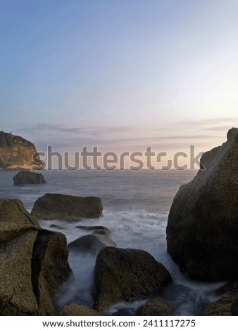Beautiful view of a rocky beach called Pangasan Beach in Pacitan, East Java, Indonesia during sunset