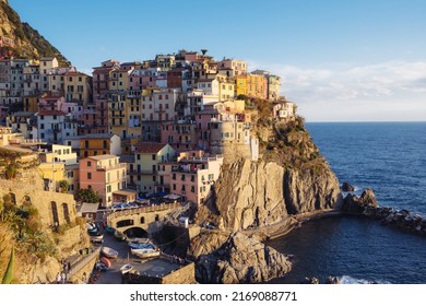 Beautiful view of rocky hills and colorful historic buildings of Manarola, tourist attraction and famous place in Liguria, Italy. Hillside over the sea at sunset. - Shutterstock ID 2169088771
