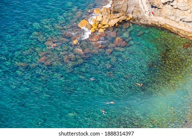 Beautiful view of of rocky mountainous coast and blue sea near Riomaggiore, Italy.