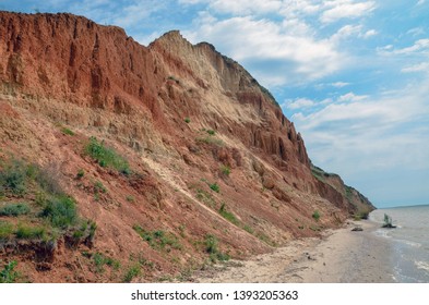 Beautiful view of sandy cliff near sea beach. Landscape of red beach cliff. - Shutterstock ID 1393205363