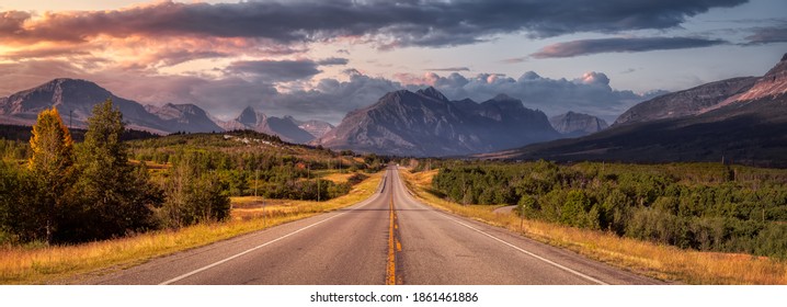 Beautiful View of Scenic Highway with American Rocky Mountain Landscape in the background. Colorful Summer Sunrise Sky. Taken in St Mary, Montana, United States. - Shutterstock ID 1861461886