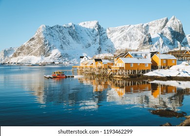 Beautiful View Of Scenic Lofoten Islands Archipelago Winter Scenery With Traditional Yellow Fisherman Rorbuer Cabins In The Historic Village Of Sakrisoy At Sunrise, Norway, Scandinavia