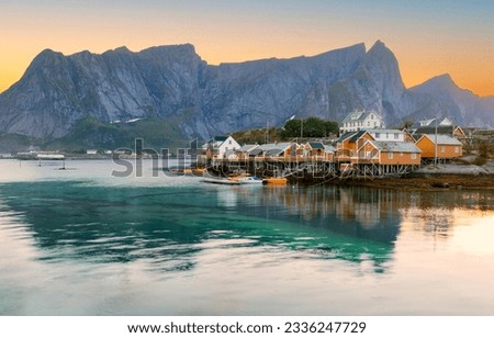 Beautiful view of scenic Lofoten Islands archipelago winter scenery with traditional yellow fisherman Rorbuer cabins in the historic village of Sakrisoy at sunrise, Norway, Scandinavia Stock photo © 