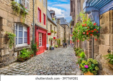 Beautiful view of scenic narrow alley with historic traditional houses and cobbled street in an old town in Europe with blue sky and clouds in summer with retro vintage Instagram grunge filter effect