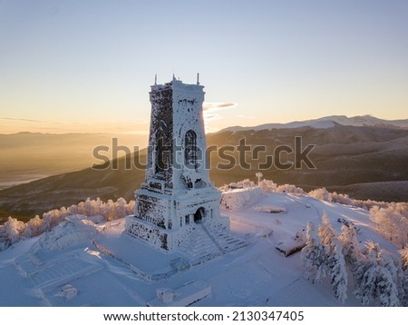 A beautiful view of Shipka peak and a monument in a snow-covered landscape