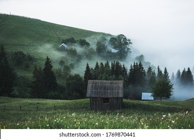 Beautiful view of small cabin surrounded by inversion fog in the wilderness after storm during summer. Hut on evergreen pasture with sea of fog in the background, Bucovina,Europe - Powered by Shutterstock