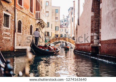 Beautiful view of a small canal in Venice with gondolas