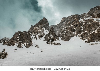 A beautiful view of snowy mountains during a summer sunrise at cambre d'aze