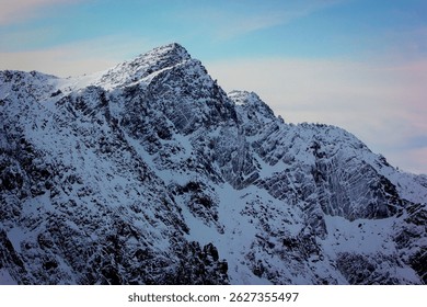 A beautiful view of snowy mountains during a summer sunrise at cambre d'aze