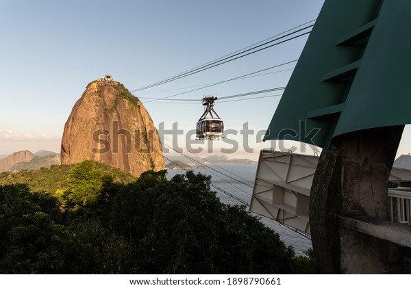 Beautiful view to Sugar Loaf mountain\
cable car over rainforest in Rio de Janeiro,\
Brazil