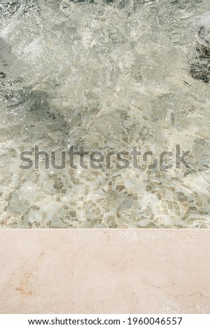 Beautiful view of swimming pool side with clear blue water with sunlight shadow wave reflections. Minimal aesthetic summer vacation concept background 商業照片 © 