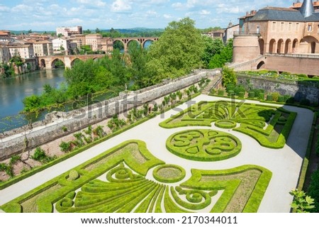 Beautiful view of the Tarn River and a garden with flowers in the Toulouse-Lautrec museum in Albi in France.