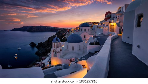 Beautiful view to the three blue domed churches in the village of Oia, Santorini, Greece, during dusk without people - Shutterstock ID 1986257918