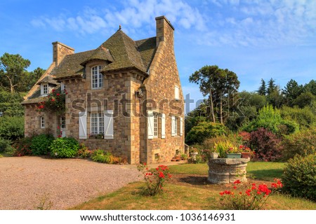 Beautiful view of a traditional French country house in Brittany, France, in summer with a blue sky
