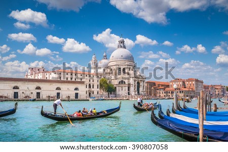 Beautiful view of traditional Gondolas on famous romantic Canal Grande with historic Basilica di Santa Maria della Salute in the background on a sunny day with blue sky and clouds in Venice, Italy Foto stock © 