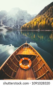 Beautiful view of traditional wooden rowing boat on scenic Lago di Braies in the Dolomites in scenic morning light at sunrise, South Tyrol, Italy