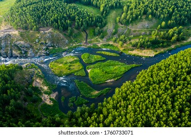 beautiful view vertically down from a great height on beautiful valley with forest and rocks, the mountain river is divided into several streams and Islands. Ural, the threshold Revun.