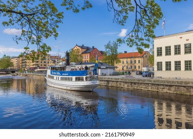Beautiful view of white tourist excursion boat on cityscape background. Sweden. Uppsala. 05.14.2022.
