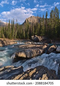 Beautiful view of wild stream Kicking Horse River at Natural Bridge in Yoho National Park, British Columbia, Canada in the Rocky Mountains in autumn with rugged rocks in the afternoon sunlight. - Shutterstock ID 2088184705