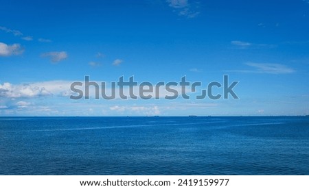 Beautiful view of the Zatoka Gdańska (Baltic Sea) and blue sky  with ships on the horizon. Beautiful view sea in the morning. Sopot Molo, Poland.