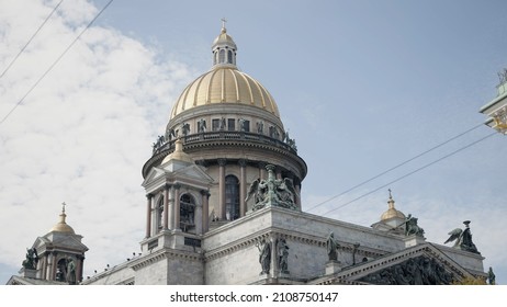 Beautiful vintage architecture of Saint Petersburg city center, majestic Saint Isaac's Cathedral. Action. Golden dome and colonnade on a blue cloudy sky background.